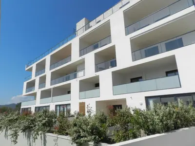 a kitchen and living room with white walls and a table at Apartment Bastion-3 by Interhome in Porto-Vecchio