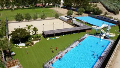 an overhead view of two swimming pools in a park at Camping Le Sagone in Sagone