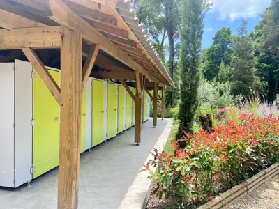 a row of stalls in a garden with flowers at Camping Le Sagone in Sagone
