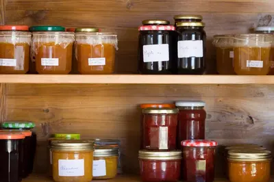 a shelf with many jars of preserves on it at A l'ombre du clocher in Calenzana