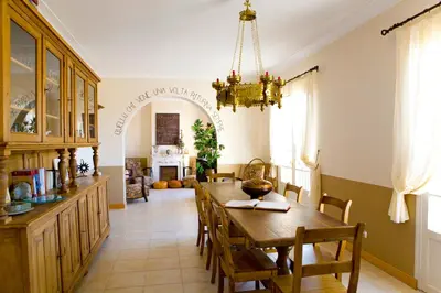 a dining room with a table and chairs at A l'ombre du clocher in Calenzana