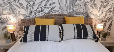 a bedroom with a bed with yellow and black pillows at A l'ombre du clocher in Calenzana