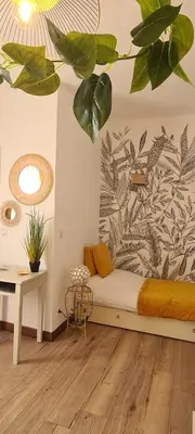 a bedroom with a bed with a plant on the wall at A l'ombre du clocher in Calenzana