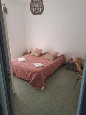 a bedroom with a bed with pink sheets and pillows at Casa tanghicciola in Levie
