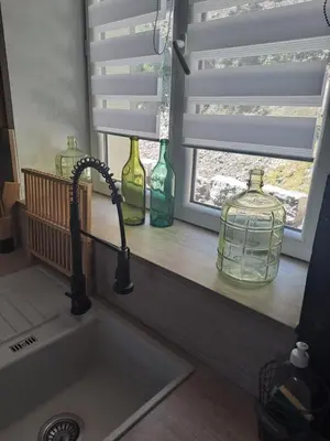 a kitchen sink with vases on a window ledge at Casa tanghicciola in Levie