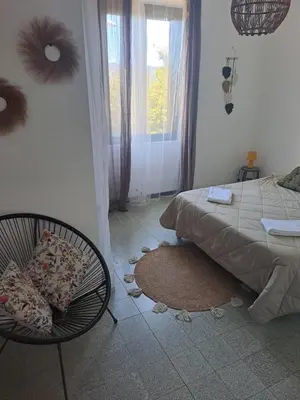a bedroom with a bed and a chair and a window at Casa tanghicciola in Levie