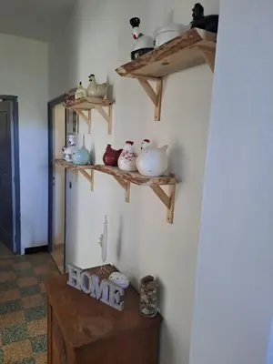 a room with wooden shelves on the wall at Casa tanghicciola in Levie