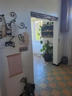 a hallway with a door to a room with plants at Casa tanghicciola in Levie