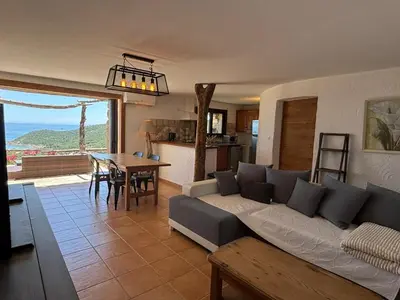 a living room with a couch and a table at CAROLE F4 in Zonza