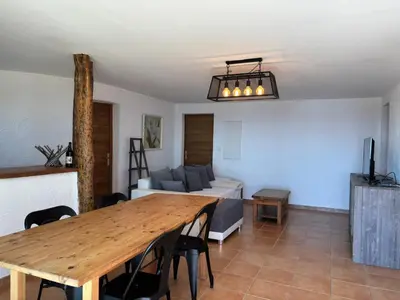 a living room with a wooden table and a couch at CAROLE F4 in Zonza