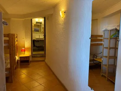 a hallway of a room with a wall and a lamp at CAROLE F4 in Zonza