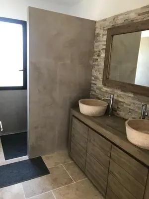 a bathroom with two sinks and a mirror at Charmante maison de village *** in Santa-Maria-Figaniella