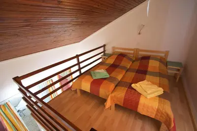 a bedroom with a bed with a colorful blanket at FKK-Feriendorf Village naturiste Club Corsicana in Linguizzetta