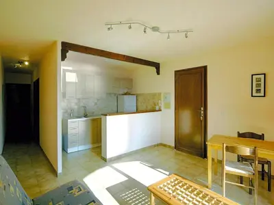a kitchen and dining room with a table and a counter at Residence Les Dauphins in Tiuccia with balcony in Casaglione