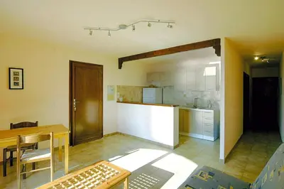 a kitchen and dining room with a table and a counter at Apartment in Corsica near Liscia Beach in Casaglione