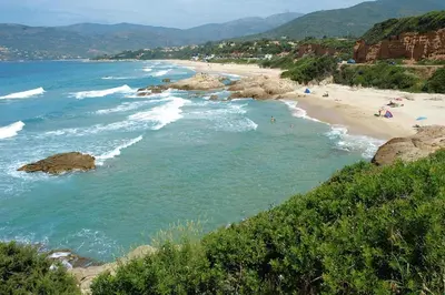 a beach with people on the sand and water at Apartment in Corsica near Liscia Beach in Casaglione