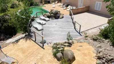 an overhead view of a wooden deck next to a swimming pool at Les Hauts de Cavanello in Zonza