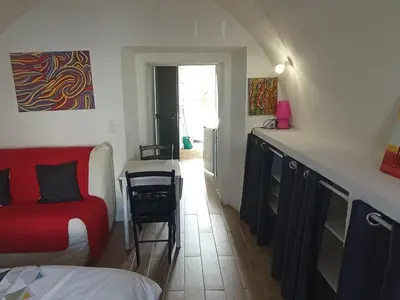 a room with a bed and a table and a chair at Casa Padulella in Moriani Plage