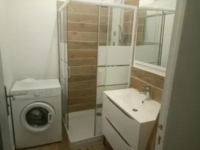 a bathroom with a washing machine and a washer at Casa Padulella in Moriani Plage