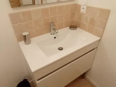 a white sink in a bathroom with a mirror at Casa Padulella in Moriani Plage