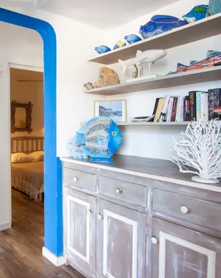 a room with a dresser with bookshelves at Residence Fium Del Cavo in Sainte-Lucie de Porto-Vecchio