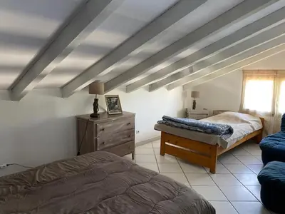 a bedroom with two beds and a dresser and a window at Residence Fium Del Cavo in Sainte-Lucie de Porto-Vecchio
