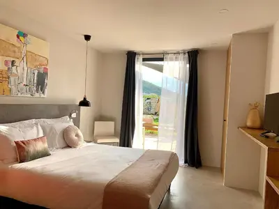 a bedroom with a bed and a large window at CASA IB in Peri
