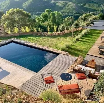 a swimming pool with chairs and a table next to it at CASA IB in Peri