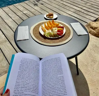 a book with a plate of fruit on a table at CASA IB in Peri