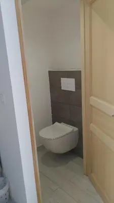 a bathroom with a white toilet in a room at Chambre d'hôte l'Escale in Sainte-Lucie de Porto-Vecchio