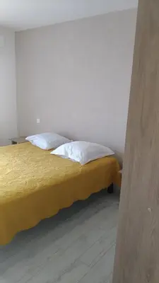 a bedroom with a bed with two pillows on it at Chambre d'hôte l'Escale in Sainte-Lucie de Porto-Vecchio