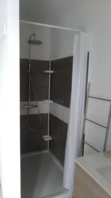 a bathroom with a shower with a shower curtain at Chambre d'hôte l'Escale in Sainte-Lucie de Porto-Vecchio