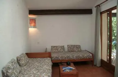 a living room with a couch and a table at Résidence Mari di Soli in Porto-Vecchio