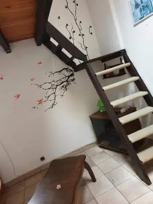a staircase in a room with a tree mural on the wall at STUDIO avec Mezzanine in Corte