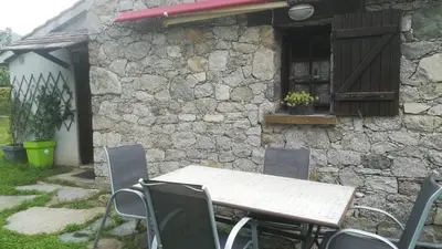 a table and chairs in front of a stone building at STUDIO avec Mezzanine in Corte