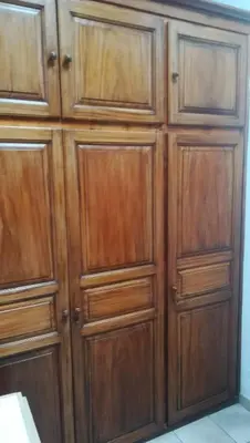 a pair of wooden cabinets in a room at STUDIO avec Mezzanine in Corte