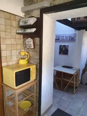 a small yellow microwave sitting on top of a table at STUDIO avec Mezzanine in Corte