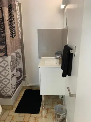 a white bathroom with a sink and a shower at Résidence EMILIA in Santa-Maria-Poggio