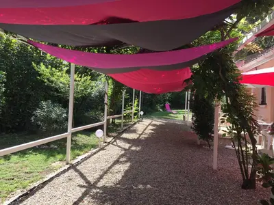 a pink tent hanging from a fence in a yard at Résidence EMILIA in Santa-Maria-Poggio
