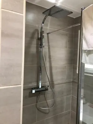 a shower with a shower head in a bathroom at Porticcio centre plage à pieds, studio-cabine 4 Pers max, promo 7 nuits in Porticcio