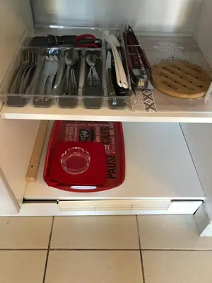 a drawer with a red plate and utensils at Porticcio centre plage à pieds, studio-cabine 4 Pers max, promo 7 nuits in Porticcio