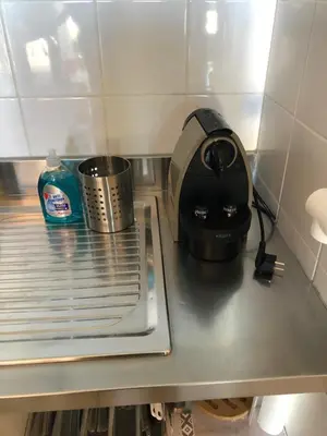 a kitchen counter with a toaster and a pot on it at Porticcio centre plage à pieds, studio-cabine 4 Pers max, promo 7 nuits in Porticcio