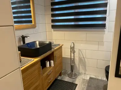 a small bathroom with a sink and a mirror at La Villa Volpaso in Belgodère