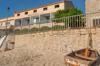 a stone wall in front of a building at HOTEL CAMPOMORO in Campomoro