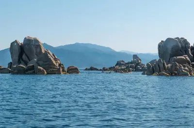 a group of rocks in the middle of the water at HOTEL CAMPOMORO in Campomoro