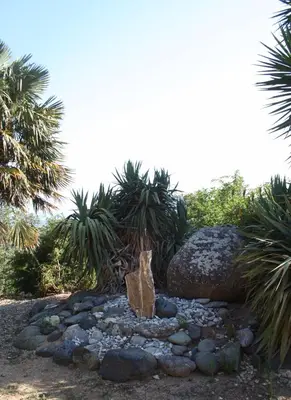 a rock garden with a statue in the middle at costa di sognu in Costa