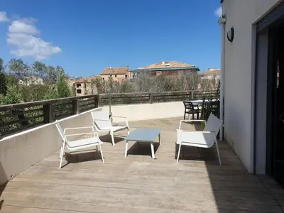 a group of chairs and a table on a balcony at APPARTEMENT TERRASSE CITA DI SALI PORTO VECCHIO in Porto-Vecchio