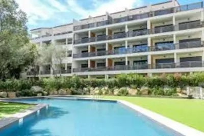 a large apartment building with a large swimming pool at APPARTEMENT TERRASSE CITA DI SALI PORTO VECCHIO in Porto-Vecchio
