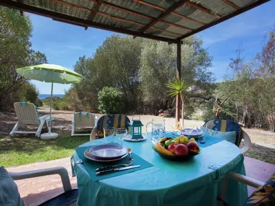 a blue table with a bowl of fruit on it at Romantic Retreat in Cargèse in Cargèse
