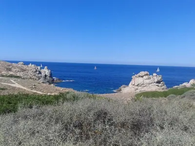 a view of the ocean with boats in the water at Romantic Retreat in Cargèse in Cargèse